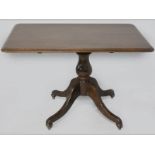 A VICTORIAN MAHOGANY TILT-TOP DINING TABLE, the well figured top with a moulded edge, standing on