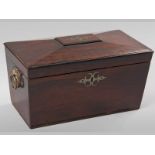 A REGENCY ROSEWOOD TEA CADDY, of sarcophagus form, the tablet and escutcheon with brass inlay, on