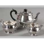 A GEORGE V SILVER THREE PIECE TEA SET BIRMINGHAM 1919, WALKER & HALL, comprising: teapot, creamer