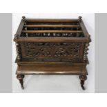 A VICTORIAN MAHOGANY CANTERBURY, the carved and pierced upper-section, barley twist pillars, above a
