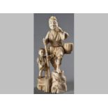 A JAPANESE SECTIONAL IVORY FIGURE OF A FARMER AND HIS SON - MEIJI PERIOD, (some losses to top of