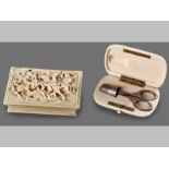 TWO ITEMS OF EUROPEAN IVORY: * An ivory case containing a silver thimble and a pair of white metal