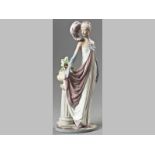 A LLADRÓ FIGURINE OF A LADY IN ART DECO COSTUME, base with printed factory mark, 34cm high.