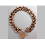 A 9CT ROSE GOLD BRACELET, fancy cuff-links with heart shaped lock and safety chain, 21cm long, 23.