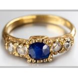 AN 18CT YELLOW GOLD AND SAPPHIRE RING, centre square sapphire flanked by two diamonds, diamonds of