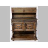 A 19TH CENTURY FLEMISH OAK BUFFET, the hinged top lifting to reveal a folding shelf above a single