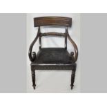 A REGENCY MAHOGANY ARMCHAIR, the reeded tablet rail above scrolled arms, on upholstered seat,