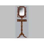 A VICTORIAN MAHOGANY GENTLEMAN'S SHAVING MIRROR STAND, the oval swing mirror above a compartmented