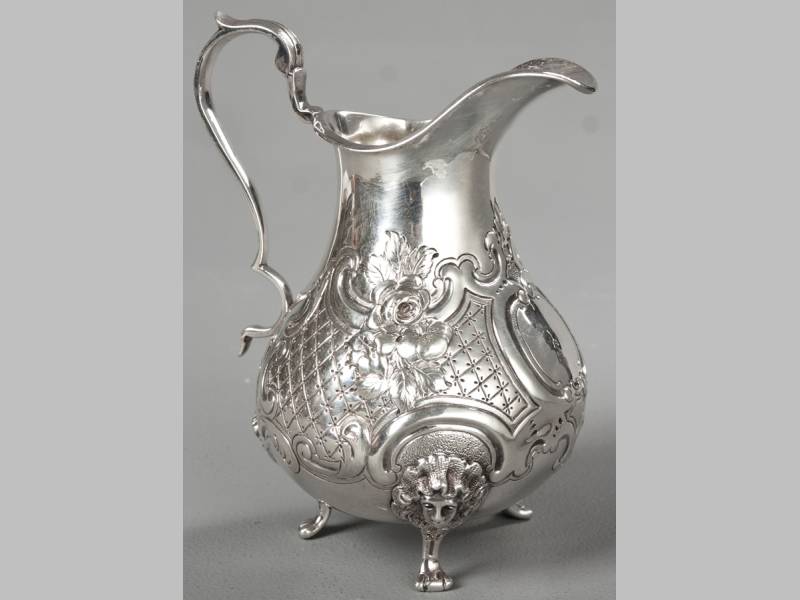 A VICTORIAN SILVER CREAMER LONDON 1855, MAKERS MARKS INDECIPHERABLE, fold-over rim, with C-scroll