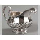 A GEORGE IV SILVER CREAMER DUBLIN 1826, JAMES LE BASS, with applied floral border, C-scroll