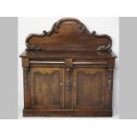 A VICTORIAN MAHOGANY CHIFFONIER, the arched back-rail decorated with heavily carved mouldings