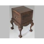 A VICTORIAN MAHOGANY CELLARET, the square top with a carved edge lifting to reveal in a tin