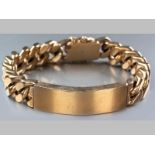 A 9CT YELLOW GOLD GENTLEMAN'S IDENTITY BRACELET, flat curb link with tongue clasp and two figure