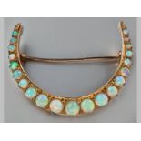 A 9CT YELLOW GOLD AND OPAL CRESCENT BROOCH, opals claw set, 3.4 long, 5.5g.