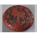 A CHINESE CINNABAR LACQUER CIRCULAR BOX, LATE 19TH/EARLY 20TH CENTURY, the top carved with a