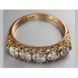 AN 18CT YELLOW GOLD AND DIAMOND RING, five claw-set diamonds of approximately 1.10cts, decorated