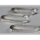 A COLLECTION OF THREE GEORGIAN IRISH SILVER SUGAR NIPS, VARIOUS DATES AND AMKERS, fiddle pattern,