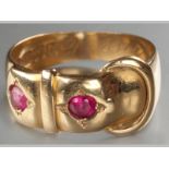 AN 18CT YELLOW GOLD AND RUBY BUCKLE RING, centre set with two rubies, ending on a solid shank, 6.