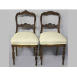 A PAIR OF 19TH CENTURY MAHOGANY DINING CHAIRS, the foliate carved top-rails and splats above