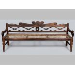 A MID-19TH CENTURY CAPE STINKWOOD RUSBANK, the shaped carved back-rail above X-stretcher and