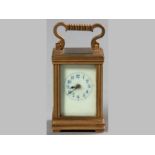 A FRENCH MINIATURE BRASS CARRIAGE CLOCK, brass carrying handle, white dial, with blue painted