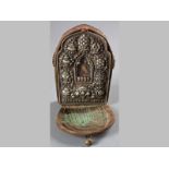 A TIBETAN WHITE METAL RELIQUARY - 18TH/19TH CENTURY, the face embossed with Buddhist symbols, with a