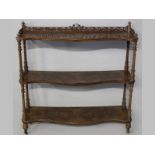AN UNUSUAL VICTORIAN WALNUT WHAT-NOT, the three serpentine shelves joined by turned and fluted