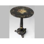 A VICTORIAN EBONIZED LAMP TABLE, the circular top painted with a realistic spray of roses and