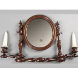 A VICTORIAN MAHOGANY HANGING MIRRROR, the oval mirror flanked by a pair of bobbin turned pillars,