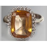 AN 18CT WHITE GOLD AND CITRINE RING, square-form citrine on a stepped and beaded setting, ending