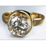 AN 18CT YELLOW GOLD AND DIAMOND SOLITAIRE, round brilliant claw set above a circular form, ending on