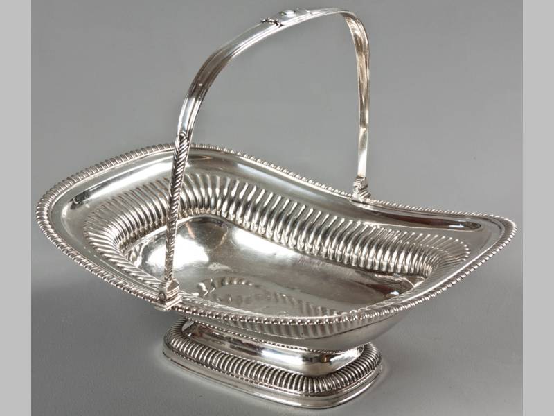 A REGENCY SILVER BASKET LONDON 1815, WILLIAM ELEY, with swing-over handle, gadrooned decoration