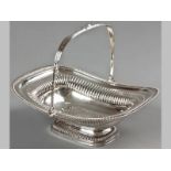 A REGENCY SILVER BASKET LONDON 1815, WILLIAM ELEY, with swing-over handle, gadrooned decoration