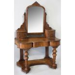 A VICTORIAN MAHOGANY DRESSING TABLE, the upper-section with two banks of small drawers, supporting
