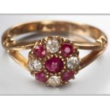 AN 18CT YELLOW GOLD, DIAMOND AND RUBY RING, centre claw set ruby surrounded by alternating four