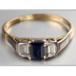 AN 18CT YELLOW AND WHITE GOLD, DIAMOND AND SAPPHIRE RING, centre square sapphire claw set, flanked