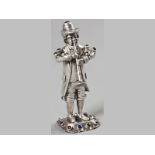 A CONTINENTAL SILVER AND SEMI-PRECIOUS STONE FIGURE OF A TRUMPET PLAYER, 11.5cm high, 109g.