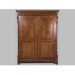 A 19TH CENTURY CONTINENTAL FLAME MAHOGANY WARDROBE, the swept pediment with bobbin moulding above