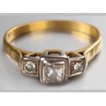 AN 18CT YELLOW GOLD AND DIAMOND RING, centre square cut diamond set on a raised base flanked by