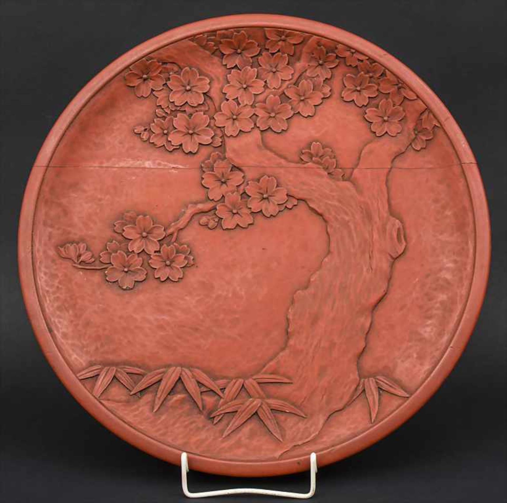 Rotlackteller / A red lacquered plate, Japan, um 1920 Material: Holz beschnitzt mit blühendem Baum