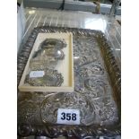 An ornate silver dressing table tray embossed with a Green Man mask and vacant escutcheon, Chester