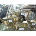 A handsome Art Deco silver four-piece tea service of footed oblong form, with composition handles,