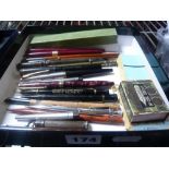 A pen lot including a red Schaffer, a red and black Conway Stewart, a black and silver Parker, a