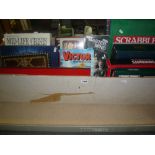 A large box of assorted board games including Scrabble, Dingbats, Mastermind, Trivial Pursuit,