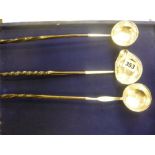 Three George III silver punch ladles, each inset with a coin and with twisted whalebone handle