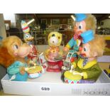 Four Feber clockwork toys, two clowns, a drumming dog and a cycling duck, and also another