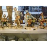 Four Capodimonte figurines - three of elderly gents on park benches and the fourth of a child