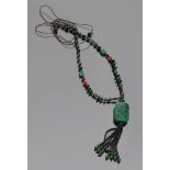NECKLACE realized with elements in jade and onyx, leaning to rectangular outline also it in graven