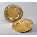 COUPLE OF DISHES IN GILDED METAL, 20TH CENTURY with stratum hurled to shoots of grapevine and fruit.