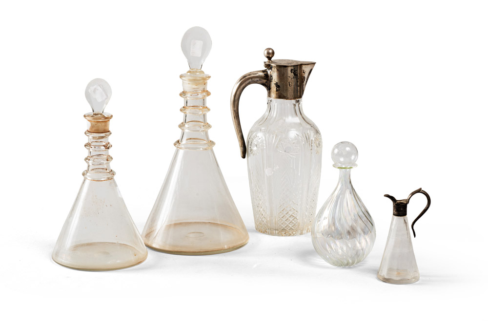 FIVE BOTTLES IN GLASS, 19TH-20TH CENTURY some blow ones. A bottle in glass cut with versaotio in